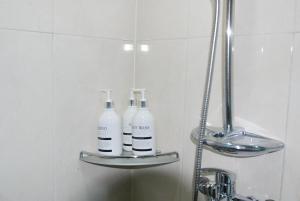two bottles are sitting on a shelf in a bathroom at Gangnam Samseong coexmall SS in Seoul
