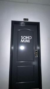 a black door with the word solo minimo on it at SohoMimi Seri Iskandar in Kampung Bota Kiri