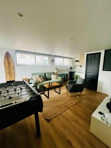 a living room with a pool table in the middle at Superbe studio neuf - 20 min Versailles (jo2024) in Les Clayes-sous-Bois