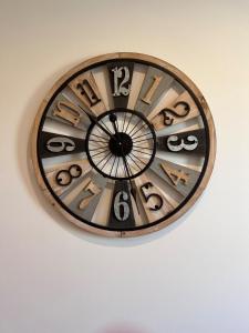 a clock is hanging on a wall at Modern 2 Bedroom Flat in Quiet Village w/ Ensuite in Bishopton