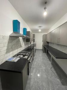a kitchen with a stove and a counter top at Luxurious En-suite Room 5 in Manchester