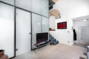 トリエステにあるThe Architect - Exclusive Loft in Ponterossoのリビングルーム(テレビ付)、階段
