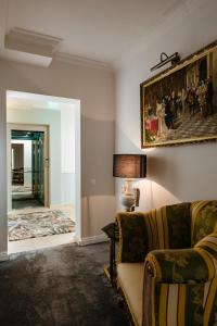 a living room with a couch and a painting on the wall at Ateneea Luxury Rooms in Cluj-Napoca