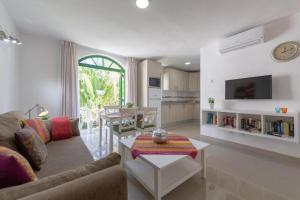 a living room with a couch and a table at Billy's Puerto de Mogán Apartments by LIVVO in Puerto de Mogán
