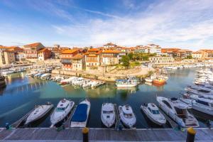 a group of boats are docked in a marina at Las Rocas in Llanes