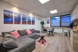 a living room with a couch and a table at Sleep1c in Hamburg