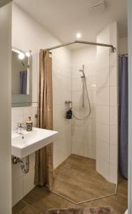 a bathroom with a sink and a shower at Sleep1c in Hamburg