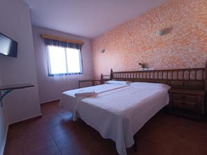 En eller flere senger på et rom på Posada Casa de Julia