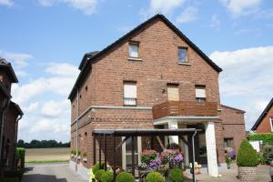 una casa de ladrillo rojo con garaje en Ferienwohnung Pöttershof, en Krefeld