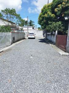 a white car parked on the side of a road at Casa de Praia do Adriano in Itapoa
