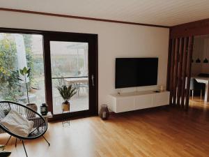 a living room with a flat screen tv on a wall at Ruhige Wohnung mit Terrasse in Telgte