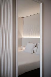 a bedroom with a white bed and a mirror at Prinsotel La Dorada & Spa in Playa de Muro +133 photos