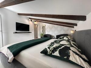 Un dormitorio con una cama y un televisor en la pared. en Apartments Prpić 1,Senj, en Senj