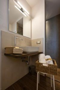 a bathroom with a sink and a mirror at Palazzo Gessi Room and Breakfast in Borghi