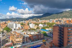 a city with buildings and mountains in the background at Classy 1BR in Chapinero in Bogotá