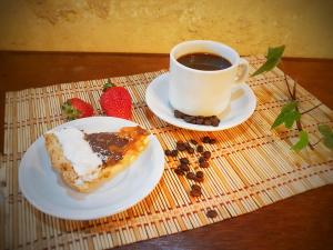 a cup of coffee and a piece of pastry on a table at Hostal Casa Grande in Villazón