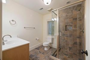 a bathroom with a shower and a toilet and a sink at 152 Augusta National in Kiawah Island