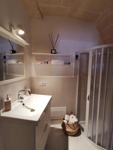 a white bathroom with a shower and a sink at Casa Lori,73 in Grottaglie