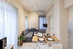 a living room with a couch and a table at Loukoumi in Ermoupoli