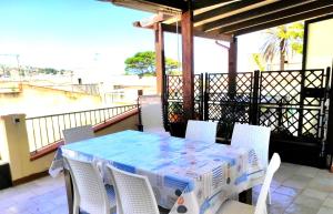 a table and chairs sitting on a balcony at Casa Laura in San Vito lo Capo