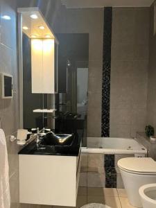 a bathroom with a sink and a toilet and a tub at El rincón del norte in Salta +5 photos