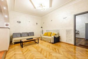 a living room with a couch and a table at Mari&Emi flat in Corvin in Budapest