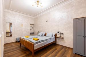 a bedroom with a bed and a ceiling at Mari&Emi flat in Corvin in Budapest