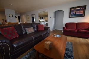 a living room with a leather couch and a coffee table at Grant's Condo in The Greens in Branson