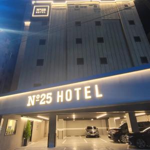 a hotel with cars parked in a parking lot at No 25 Hotel Dongam Branch in Incheon