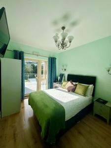 a bedroom with a large bed and a chandelier at Shandon Bells Guest House in Cork