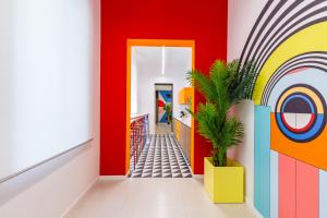 um corredor com paredes coloridas e uma planta em Januarius Domus em Nápoles