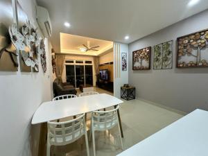 a living room with a white table and chairs at JB Twin Galaxy Residence Studio City View in Johor Bahru