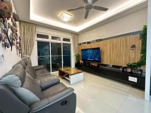 a living room with a couch and a flat screen tv at JB Twin Galaxy Residence Studio City View in Johor Bahru