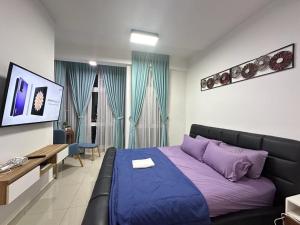 a bedroom with a purple bed and a couch at JB Twin Galaxy Residence Studio City View in Johor Bahru