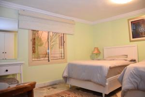 a bedroom with two beds and a window at منتجع ريف خزيمة - الصباح in Al Madinah