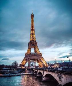 a view of the eiffel tower at night at STUDIO GARE MONTPARNASSE in Paris
