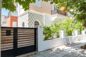 a black gate in front of a white house at Kosnian City Suites B in Kos