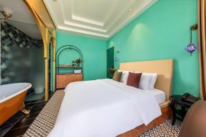 a bedroom with a bed and a bathtub and a tub at Secret Garden Hotel in Ho Chi Minh City