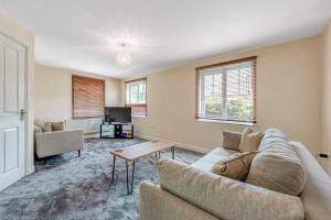 uma sala de estar com um sofá e uma mesa em Spectacular House with Parking em Chorley