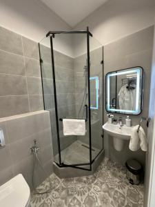 a bathroom with a shower and a sink at Five's Hotel Astana in Astana +33 photos