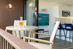a small table and chairs in a living room at Trocean View, Amazing Ocean View in Rio Grande