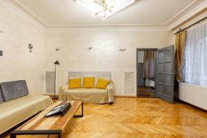 a living room with a bed and a table at Mari&Emi flat in Corvin in Budapest