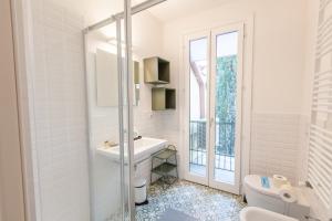 a white bathroom with a sink and a toilet at Santa Maria Novella Apartment in Florence