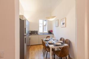 a kitchen and dining room with a table and chairs at Santa Maria Novella Apartment in Florence