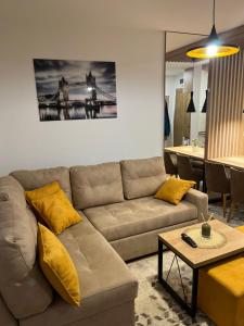 a living room with a couch and a table at Apartman MM Zlatibor in Zlatibor