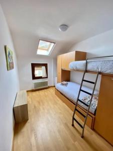 a room with two bunk beds and a ladder at Apartamento Otal in Biescas