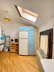 a kitchen with a refrigerator and a couch in a room at Apartamento Otal in Biescas