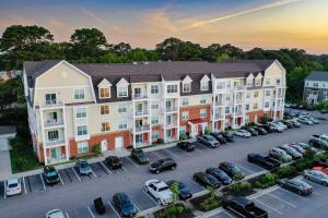 an aerial view of a apartment complex with cars parked in a parking lot at H4N Furnished Apartments Near Naval Station Norfolk in Norfolk