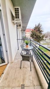 a balcony with a table and chairs on a balcony at KYD VILA - Studiouri si Apartamente la 100m de Plaja Debarcader in Eforie Nord