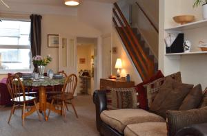 a living room with a table and a couch at Tilling View with private parking in Rye